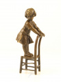 Bronze statues of a little girl in a dress on a stool 