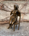 Statue of a naked woman on chair made of bronze 3