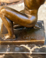 Bronze statue - Naked man kneels