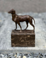 Bronze statue of a hunting dog on a marble plinth