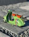 Retro model of a green scooter VESPA made of sheet metal