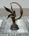 Large sculpture of the Moon Fairy on a crescent moon - modern art