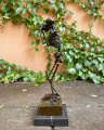 A bronze statue of a skeleton