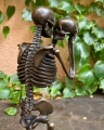 A bronze statue of a skeleton
