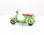 Retro model of a green scooter made of sheet metal
