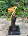 Bronze statue of a naked woman on the wrist