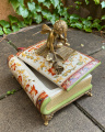 Casket Angel sitting on the book made of porcelain