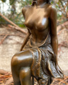 Statue of a lady on chair made of bronze