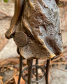 Statue of a lady on chair made of bronze