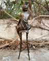 Statue of a woman on chair made of bronze