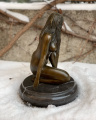 Erotic bronze figurine of a seated girl