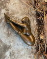 Statue of a tied nude woman made of bronze