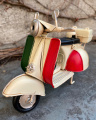 Retro model of a scooter made of sheet metal - white color