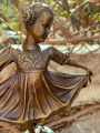 Statue of a cute girl in dress made of bronze 2