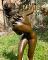 Statue of a nude woman with gold rings made of bronze
