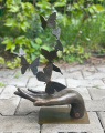 Bronze statue of butterflies on a hand