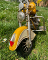 Metal model of a yellow motorcycle