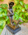 Bronze statue of a girl walking the dog